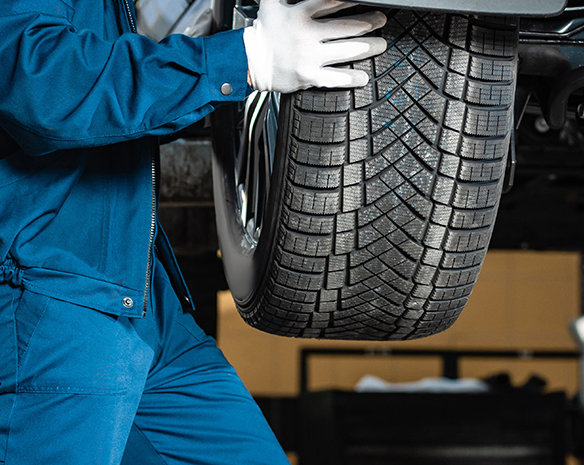 mechanic installing wheel